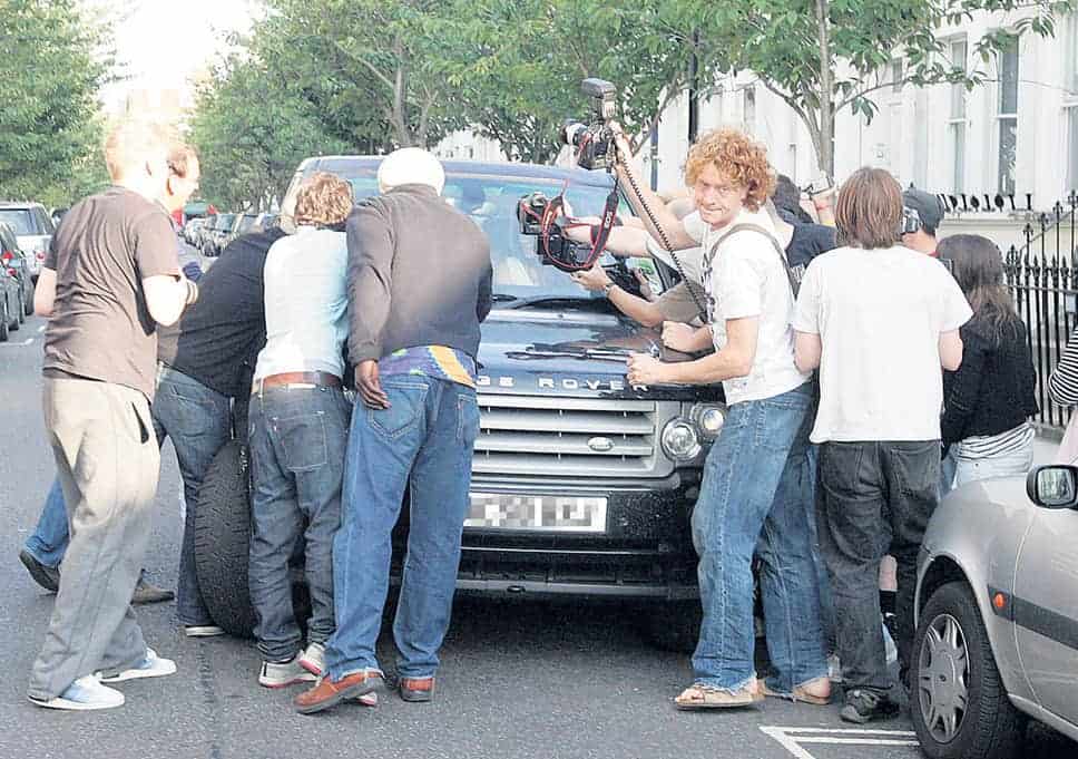 Liz Hurley surrounded by paparazzi outside her home